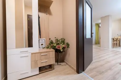 a dressing room with a mirror and a vase of flowers at City Central 1-Bed Apartments in Plovdiv
