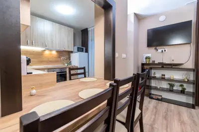 a kitchen and dining room with a table and chairs at City Central 1-Bed Apartments in Plovdiv