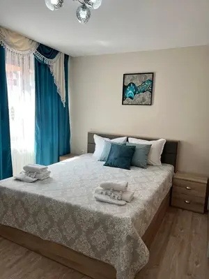 a bedroom with a bed with two towels on it at Guest House Tatiana /Къща за гости ТАТЯНА in Petrich