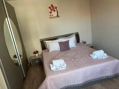 a small bedroom with a bed with towels on it at Guest House Tatiana /Къща за гости ТАТЯНА in Petrich
