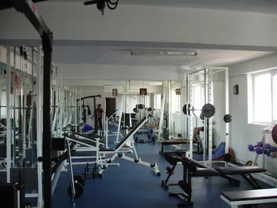 a gym with several tread machines in a room at Komitite Complex in Chuchuligovo