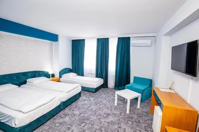 a hotel room with two beds and a flat screen tv at Komitite Complex in Chuchuligovo
