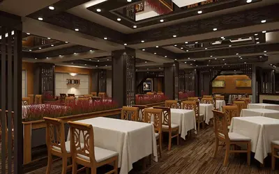 a dining room with white tables and wooden chairs at Komitite Complex in Chuchuligovo
