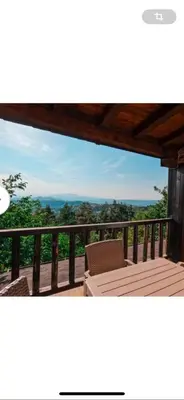 a balcony with a table and a view of the mountains at Александрова вила 2 in Zlatograd