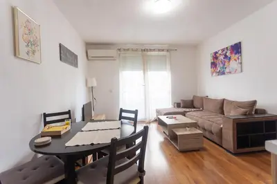 a living room with a table and a couch at Karastoyanovi's apartment- Studentski grad in Sofia