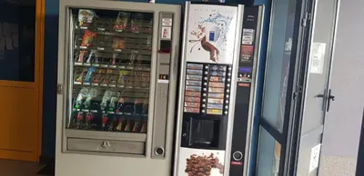 a vending machine with drinks and drinks in it at Karastoyanovi's apartment- Studentski grad in Sofia