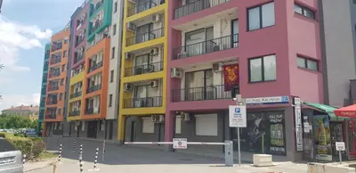 a row of colorful buildings on a city street at Karastoyanovi's apartment- Studentski grad in Sofia