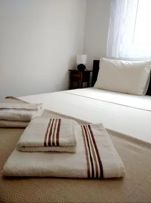 a bedroom with a bed with two towels on it at Karastoyanovi's apartment- Studentski grad in Sofia
