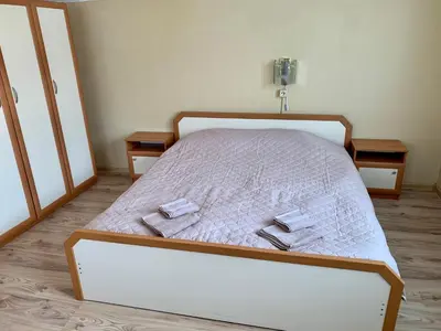 a bedroom with a bed with two towels on it at Sunny House in Madzhare