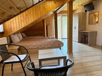 a bedroom with a bed and a table and chairs at Advel Guest House in Madzhare