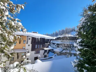 arial view of a snow covered city with buildings at Гранд Манастира Лукс in Pamporovo