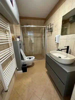 a bathroom with a toilet and a sink and a shower at Apartaments Filipopolis in Plovdiv