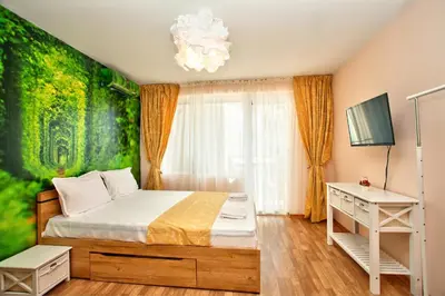a bedroom with a bed with a green wall at Aurora Oasis - AC & Lift in Vibrant Downtown Sofia by Flat Mаnager in Sofia