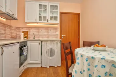 a kitchen with a table with a bowl of fruit on it at Aurora Oasis - AC & Lift in Vibrant Downtown Sofia by Flat Mаnager in Sofia