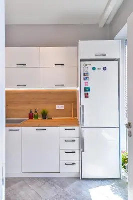 a kitchen with white cabinets and a white refrigerator at - The Blue Apartment - 1BD with Artistic Interior Design by Flat Mаnager in Sofia