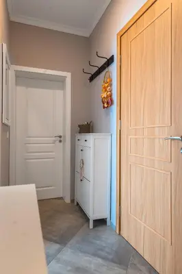 a bathroom with a white refrigerator and a door at - The Blue Apartment - 1BD with Artistic Interior Design by Flat Mаnager in Sofia