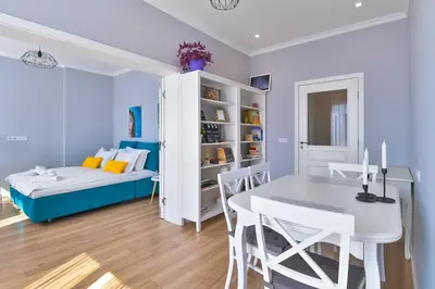 a dining room with a bed and a table at - The Blue Apartment - 1BD with Artistic Interior Design by Flat Mаnager in Sofia