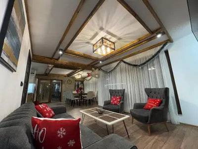 a living room with a couch and chairs and a table at 4U LUXURY VILLA in Dospat