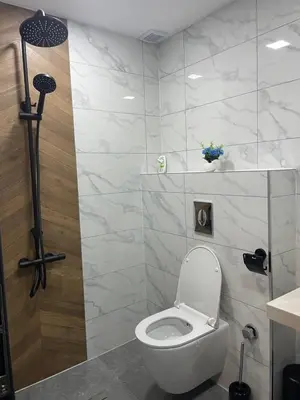 a bathroom with a white toilet in a room at 4U LUXURY VILLA in Dospat