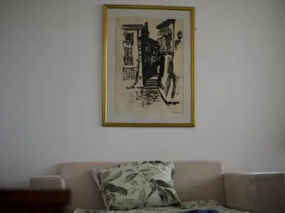 a picture hanging on a wall above a couch at ParkView Complex Large Flat Next to Ski Lift in Bansko
