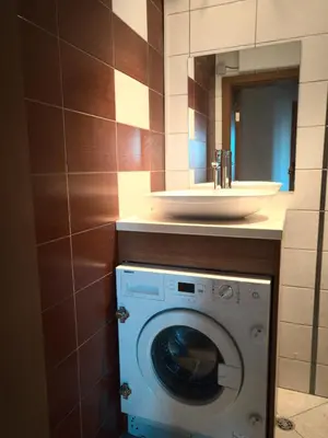 a bathroom with a washing machine and a sink at ParkView Complex Large Flat Next to Ski Lift in Bansko