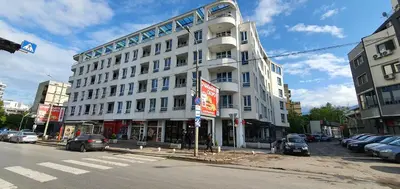 a large white building on the corner of a street at Colonel apartment 936 in Sofia