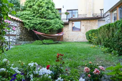 a hammock in the yard of a house at Marand Villas in Bansko