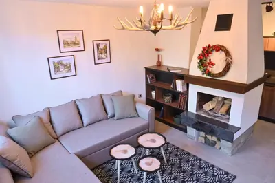 a living room with a couch and a fireplace at Marand Villas in Bansko