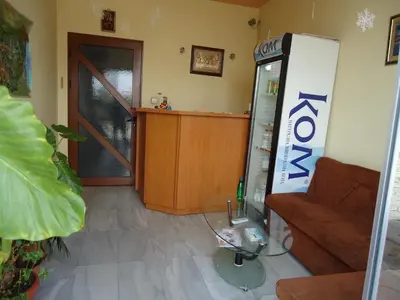 a living room with a couch and a soda machine at Dionis Hotel in Petrich