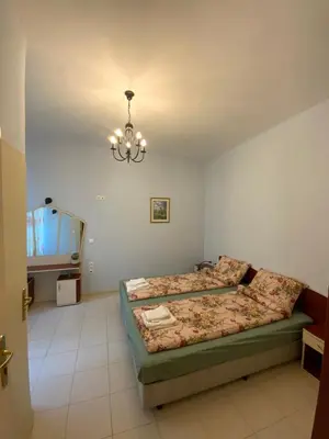 a bedroom with two beds and a chandelier at 113 in Sofia with 2BR and 2 full bath in Sofia