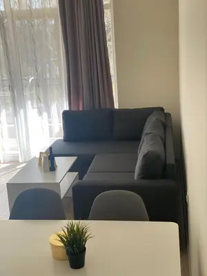 a living room with a couch and a table at Green park Sandanski in Sandanski