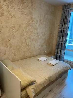 a bedroom with a bed with two towels on it at Colonel apartment 938 in Sofia