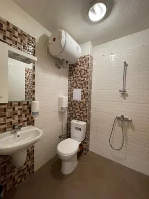 a bathroom with a toilet and a sink and a shower at Colonel apartment 938 in Sofia
