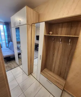 a reflection of a room with a mirror and a closet at Colonel apartment 944 in Sofia