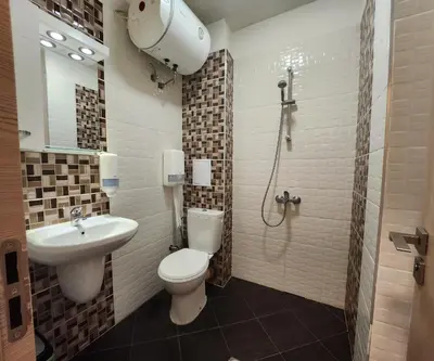 a bathroom with a toilet and a sink and a shower at Colonel apartment 944 in Sofia