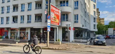 a person riding a bike down a street in front of a building at Colonel apartment 946 in Sofia