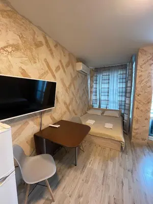 a small room with a desk and a table with chairs at Colonel apartment 946 in Sofia