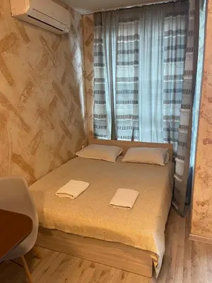 a small bedroom with a bed and a window at Colonel apartment 946 in Sofia