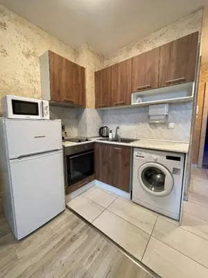 a kitchen with a white refrigerator and a washing machine at Colonel apartment 947 in Sofia