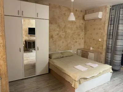 a small bedroom with a bed and a tv at Colonel apartment 958 in Sofia