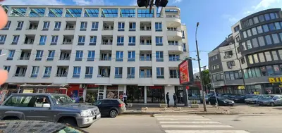 a large white building with cars parked in front of it at Colonel apartment 958 in Sofia