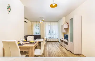 a dining room and living room with a table and chairs at Stylish 2BD Apartment with a Nice Cozy Terrace by Flat Mаnager in Plovdiv