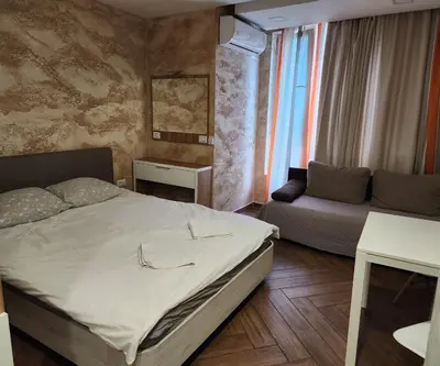 a small bedroom with a bed and a couch at Colonel apartment Luxury in Sofia