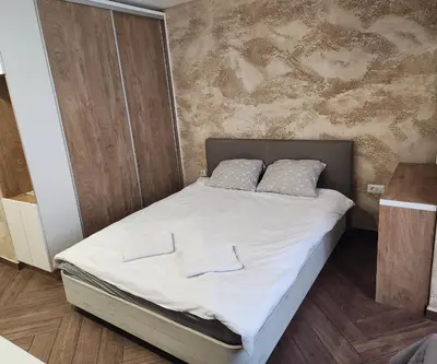 a bedroom with a bed with white sheets and two pillows at Colonel apartment Luxury in Sofia