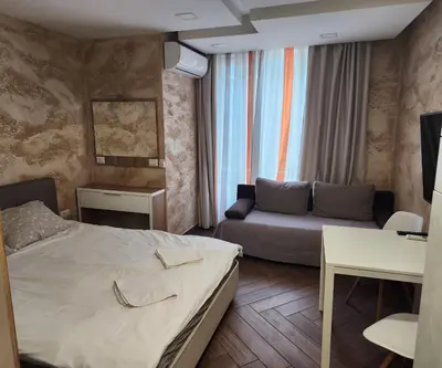 a hotel room with a bed and a couch at Colonel apartment Luxury in Sofia