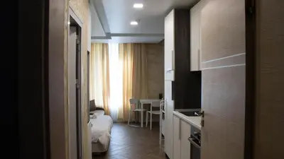 a hotel room with a bedroom and a bed and a kitchen at Colonel apartment Luxury in Sofia