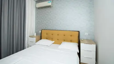 a bedroom with a white bed and a air conditioner at Colonel apartment dream in Sofia