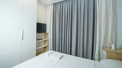 a bedroom with a white bed and a window at Colonel apartment dream in Sofia