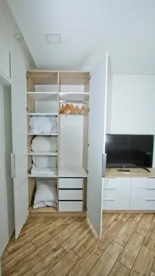 a walk in closet with white cabinets and a television at Colonel apartment dream in Sofia