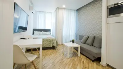 a living room with a couch and a table at Colonel apartment Bijou in Sofia
